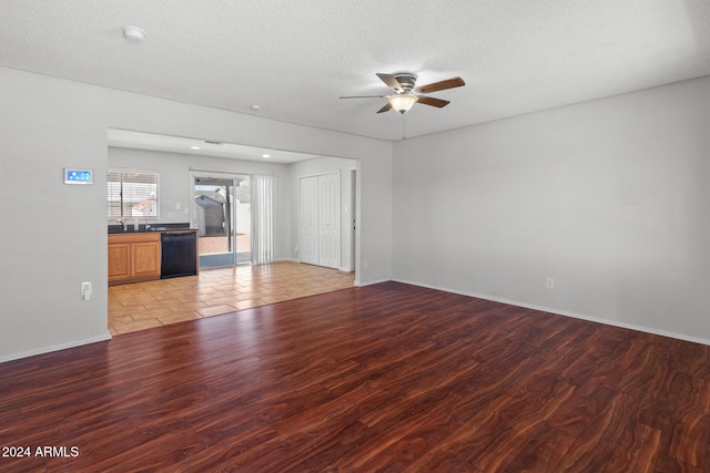 unfurnished living room with ceiling fan, light hardwood / wood-style flooring, and a textured ceiling