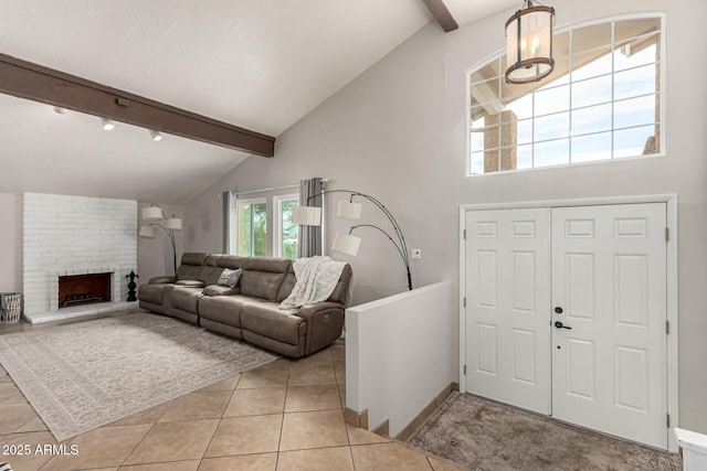 3358 W Sandra Ter, Phoenix, AZ 85053 - entryway with beam ceiling, light tile patterned floors, high vaulted ceiling, baseboards, and a fireplace