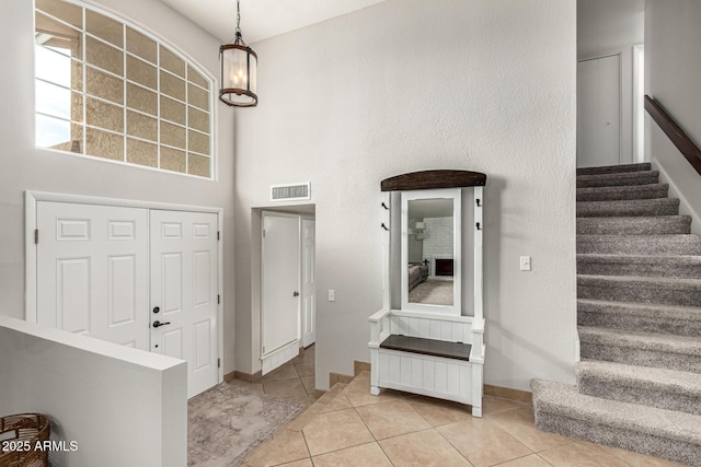 3358 W Sandra Ter, Phoenix, AZ 85053 - entrance foyer with stairs, light tile patterned floors, and baseboards
