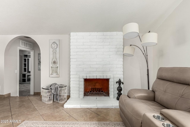 3358 W Sandra Ter, Phoenix, AZ 85053 - living room with arched walkways and a fireplace