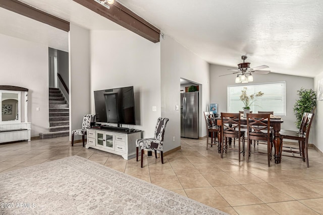 3358 W Sandra Ter, Phoenix, AZ 85053 - living area featuring vaulted ceiling, light tile patterned floors, ceiling fan, stairs, and baseboards