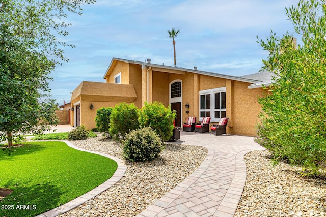 3358 W Sandra Ter, Phoenix, AZ 85053 - view of front facade with stucco siding, an outdoor living space, a patio, and a front lawn