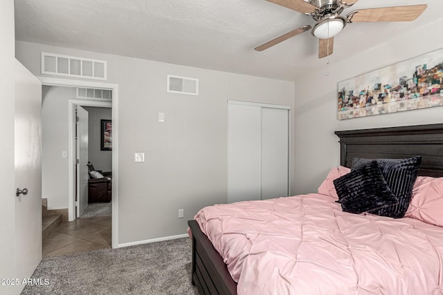 3358 W Sandra Ter, Phoenix, AZ 85053 - tiled bedroom featuring a closet, carpet, ceiling fan, and baseboards