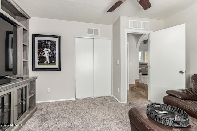 3358 W Sandra Ter, Phoenix, AZ 85053 - carpeted living room featuring arched walkways, a ceiling fan, and baseboards