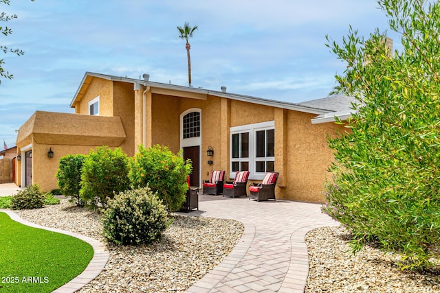 3358 W Sandra Ter, Phoenix, AZ 85053 - view of front of property with stucco siding, outdoor lounge area, and a patio