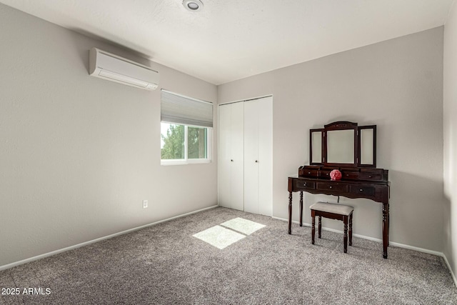 3358 W Sandra Ter, Phoenix, AZ 85053 - bedroom with an AC wall unit, carpet flooring, a closet, and baseboards