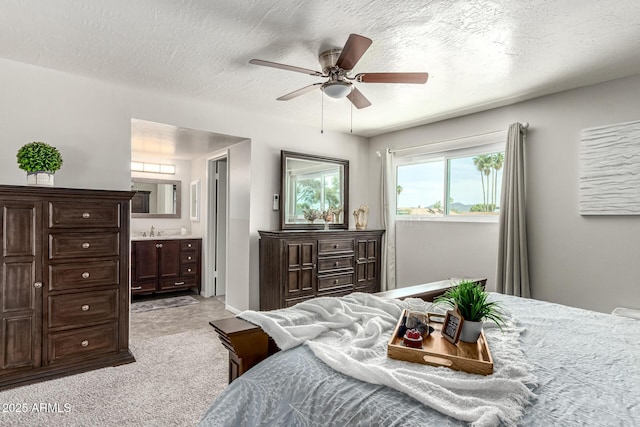 3358 W Sandra Ter, Phoenix, AZ 85053 - bedroom with light colored carpet, a sink, connected bathroom, and ceiling fan