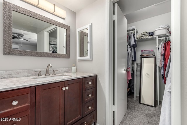 3358 W Sandra Ter, Phoenix, AZ 85053 - bathroom featuring vanity, a walk in closet, and ceiling fan