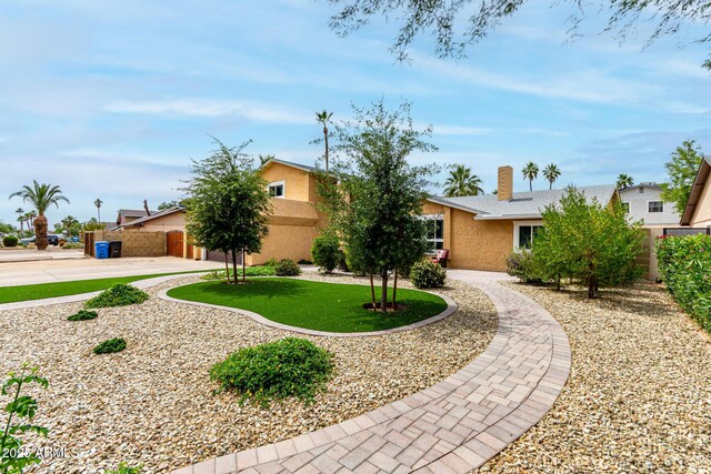 3358 W Sandra Ter, Phoenix, AZ 85053 - view of front of house with stucco siding and a chimney