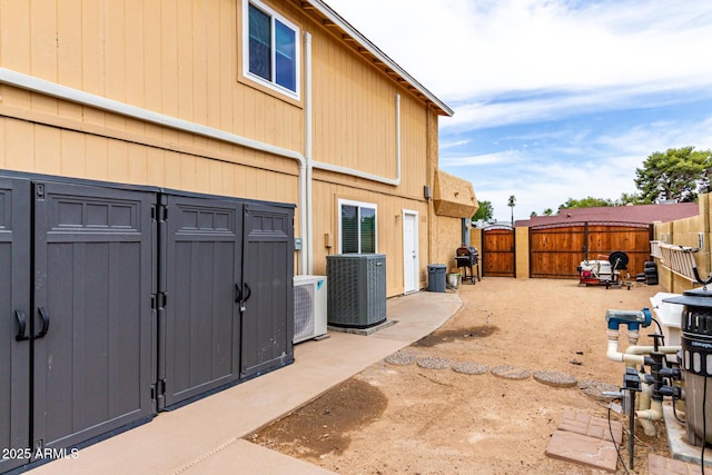 3358 W Sandra Ter, Phoenix, AZ 85053 - back of house with central air condition unit, a fenced backyard, and a shed