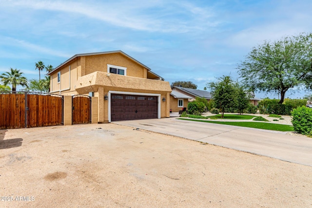 3358 W Sandra Ter, Phoenix, AZ 85053 - view of property exterior with a gate, a garage, stucco siding, and driveway