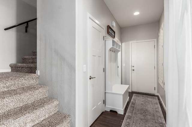 staircase featuring baseboards, wood finished floors, and recessed lighting