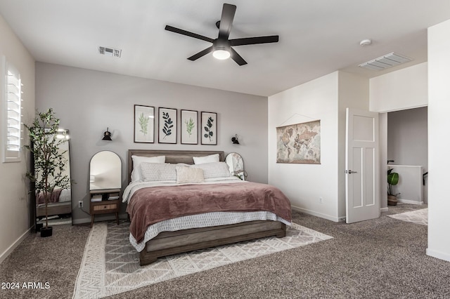 carpeted bedroom featuring baseboards, visible vents, and a ceiling fan