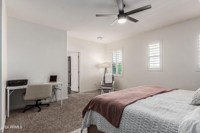 carpeted bedroom featuring ceiling fan, visible vents, and baseboards