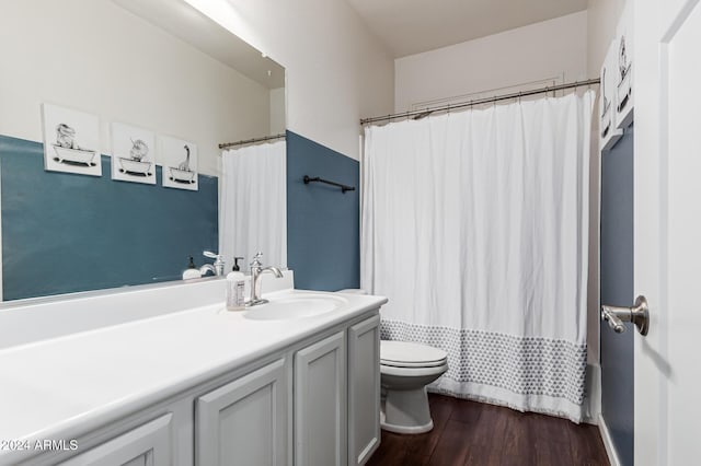 full bathroom featuring a shower with curtain, vanity, toilet, and wood finished floors