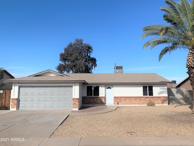 ranch-style house with a garage, brick siding, fence, and driveway