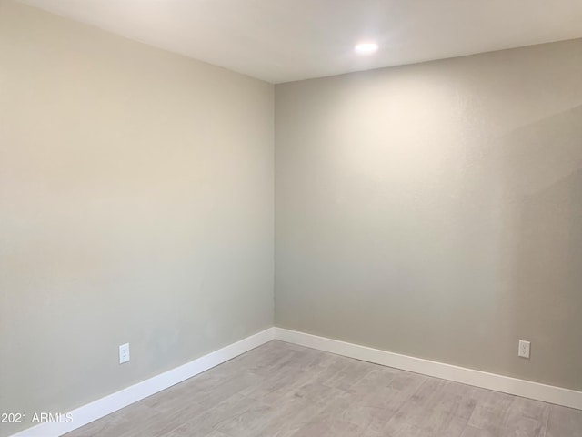 spare room with light wood-type flooring and baseboards