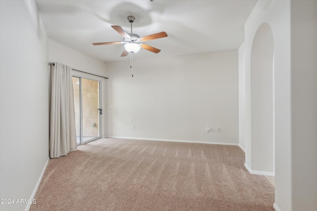 unfurnished room with light colored carpet, baseboards, and ceiling fan