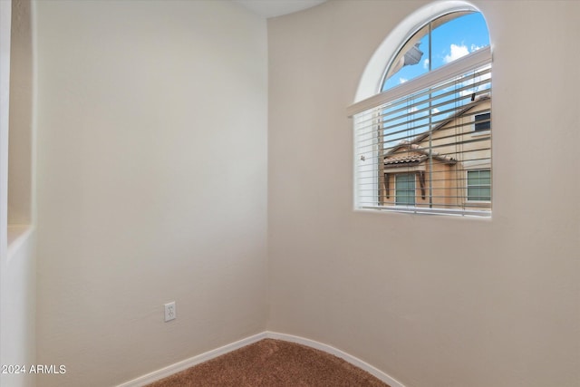 carpeted spare room with baseboards