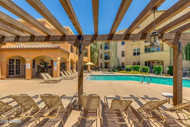 pool with a patio, fence, and a pergola