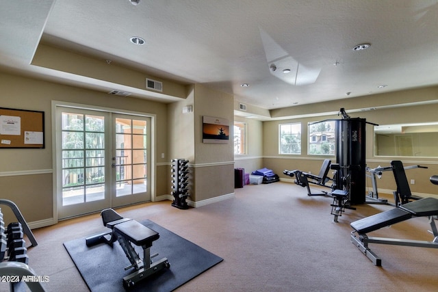 workout area featuring visible vents, french doors, baseboards, and carpet floors