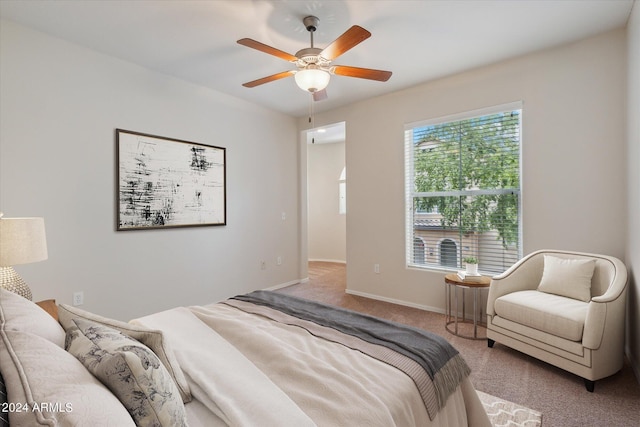 carpeted bedroom featuring ceiling fan and baseboards