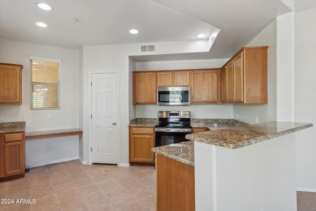 kitchen with visible vents, recessed lighting, a peninsula, brown cabinetry, and stainless steel appliances