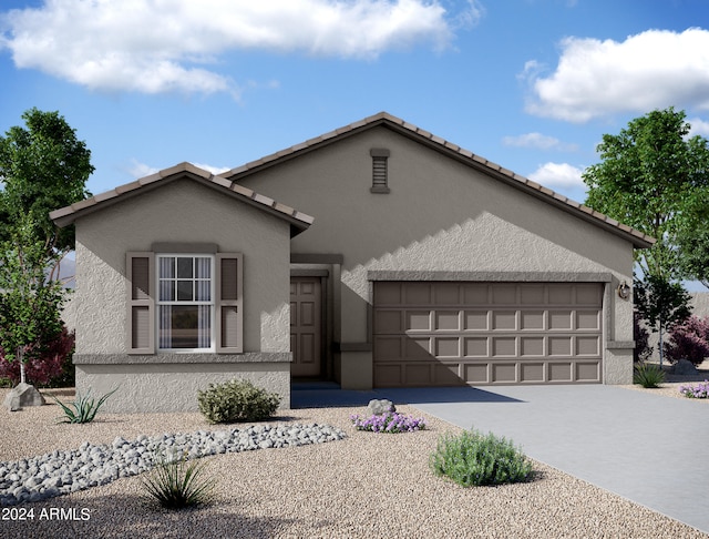 view of front of home featuring an attached garage, driveway, and stucco siding