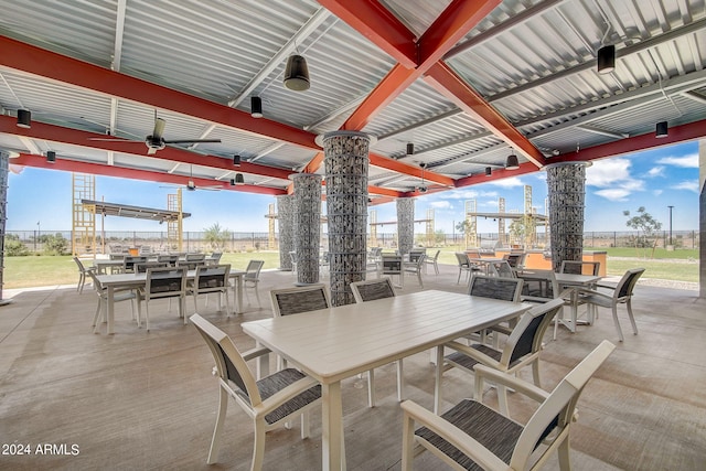 view of patio / terrace with outdoor dining area, a ceiling fan, and fence