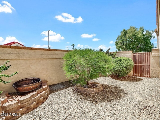 view of yard with a fire pit