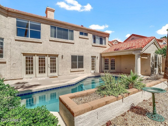 back of house with a patio