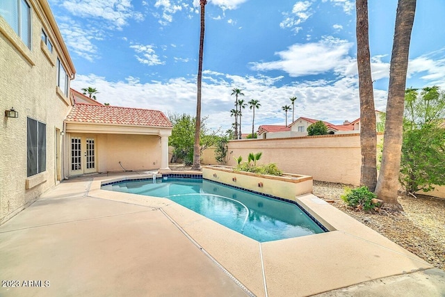 view of swimming pool with french doors and a patio area