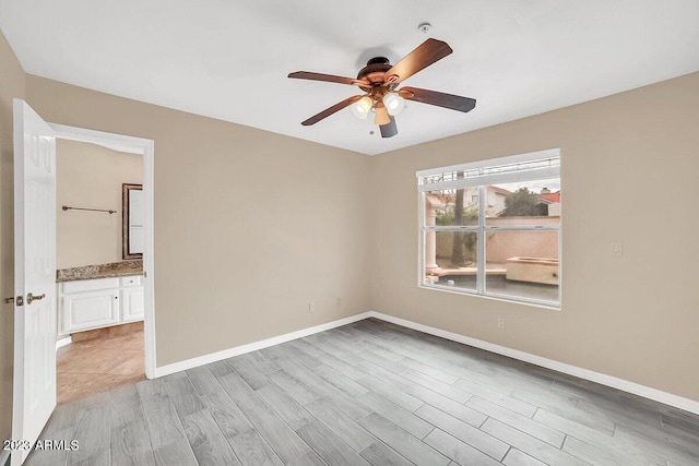 empty room featuring light wood-type flooring and ceiling fan