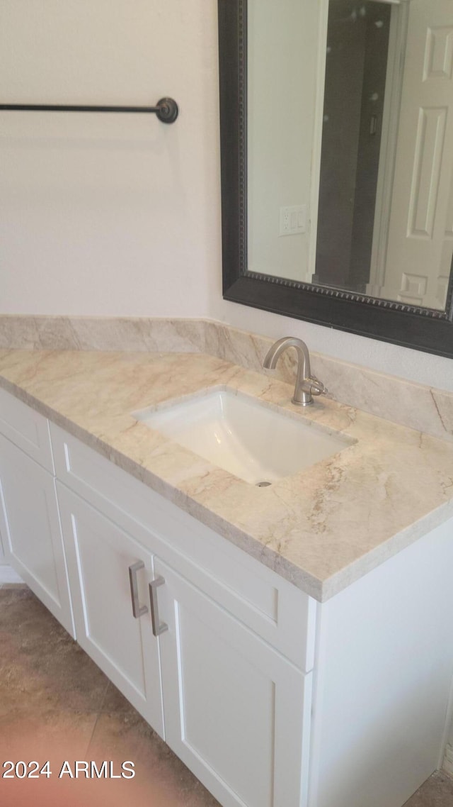 bathroom featuring tile patterned flooring and vanity