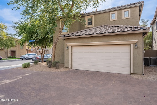 mediterranean / spanish house with a garage