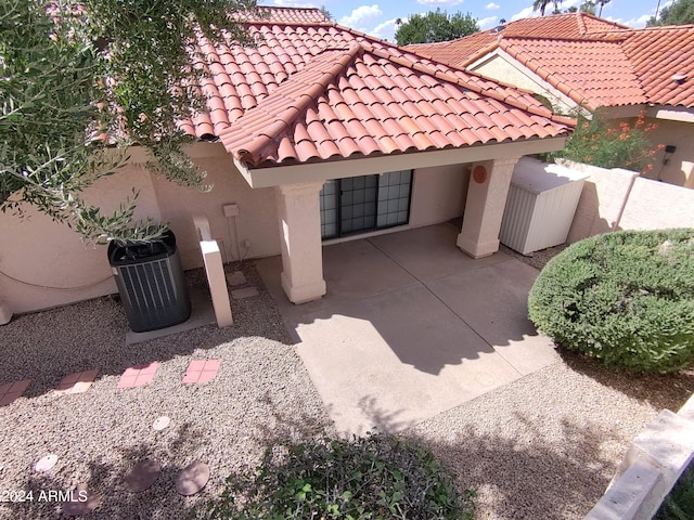 view of side of property featuring a patio and central AC unit