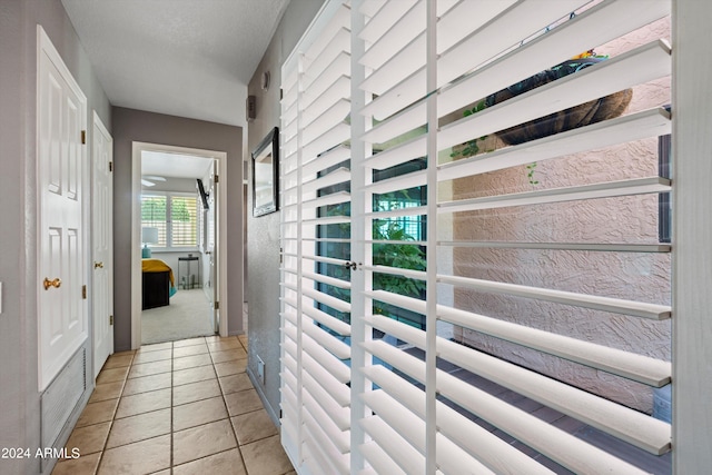 hallway with light tile patterned floors