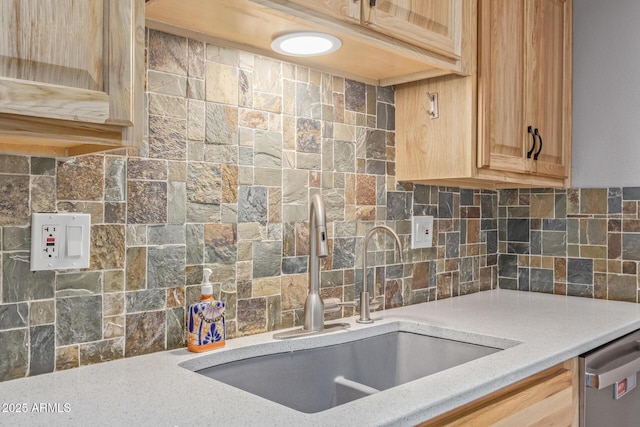 kitchen featuring tasteful backsplash, light brown cabinetry, sink, and dishwasher