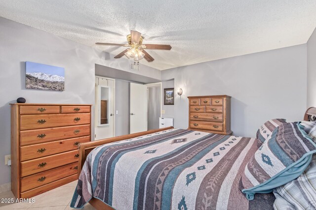 bedroom featuring light tile patterned floors, a textured ceiling, and ceiling fan