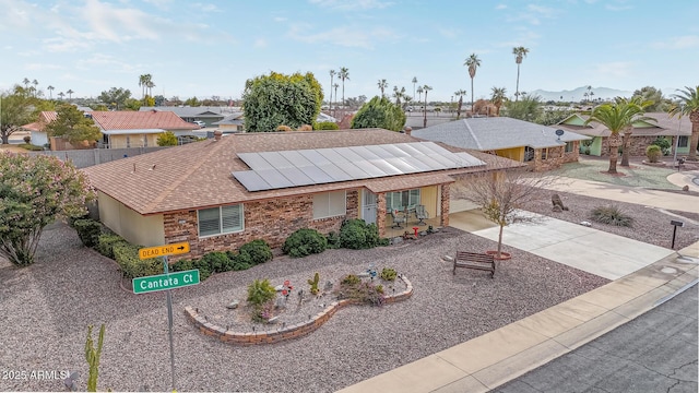 single story home featuring a mountain view and solar panels