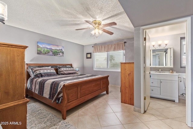 bedroom featuring ceiling fan, ensuite bath, a textured ceiling, and light tile patterned flooring