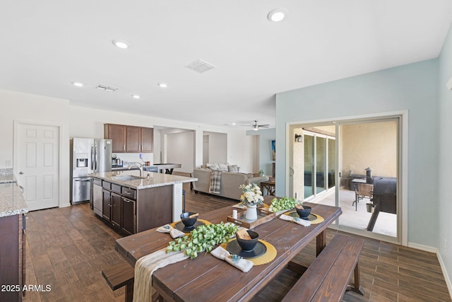 dining room featuring ceiling fan, dark hardwood / wood-style flooring, and sink