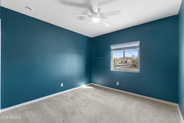 carpeted empty room featuring ceiling fan