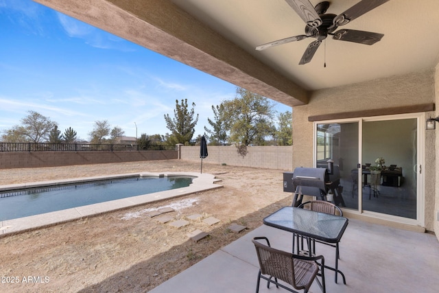 view of patio / terrace with ceiling fan and a fenced in pool