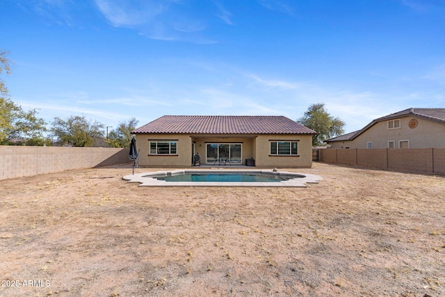 back of house with a fenced in pool