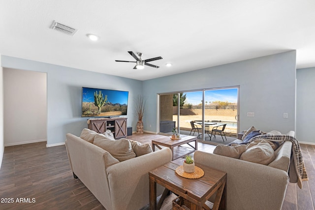 living room with dark wood-type flooring and ceiling fan