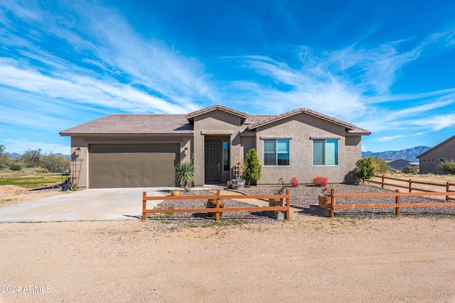 view of front of property featuring a mountain view and a garage