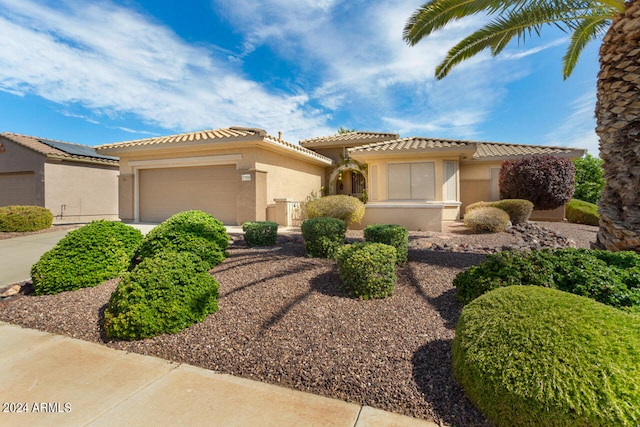 mediterranean / spanish home with a garage