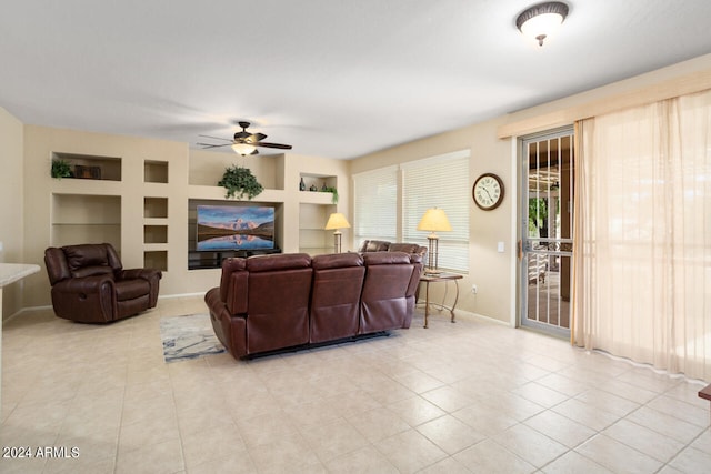 living room featuring light tile patterned floors, ceiling fan, and built in features