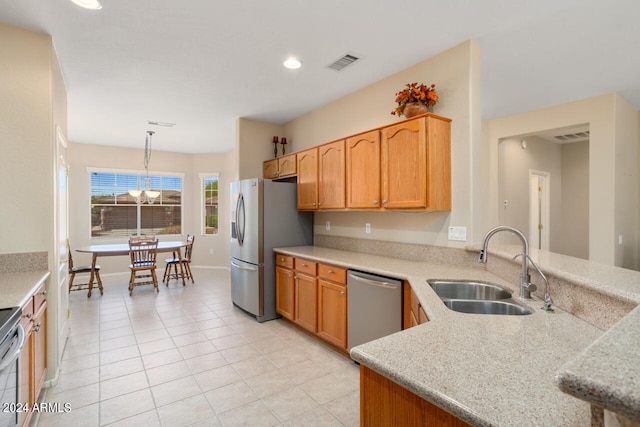 kitchen with light tile patterned flooring, sink, decorative light fixtures, a chandelier, and stainless steel appliances